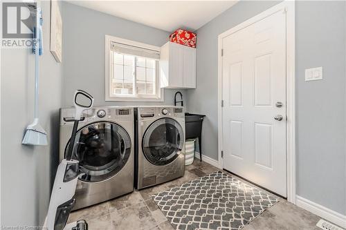 Laundry area featuring cabinets and washer and clothes dryer - 12 Hardcastle Place, Cambridge, ON - Indoor Photo Showing Laundry Room