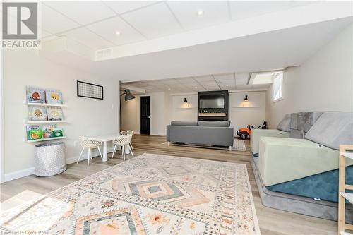 Living room with a drop ceiling and light hardwood / wood-style floors - 12 Hardcastle Place, Cambridge, ON - Indoor