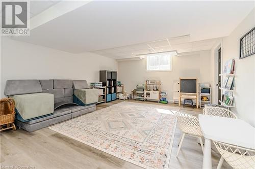 Living room featuring wood-type flooring and a drop ceiling - 12 Hardcastle Place, Cambridge, ON - Indoor Photo Showing Other Room