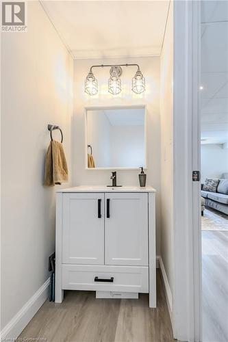 Bathroom featuring vanity, wood-type flooring, and crown molding - 12 Hardcastle Place, Cambridge, ON - Indoor Photo Showing Other Room