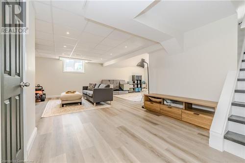 Living room with a drop ceiling and light hardwood / wood-style floors - 12 Hardcastle Place, Cambridge, ON - Indoor