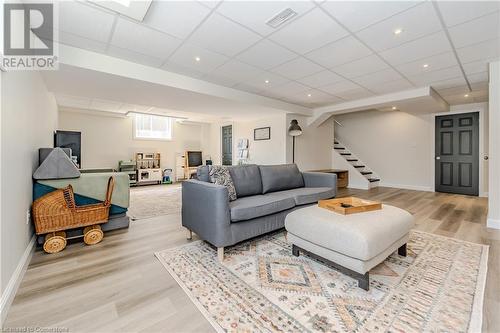 Living room with a drop ceiling and light wood-type flooring - 12 Hardcastle Place, Cambridge, ON - Indoor