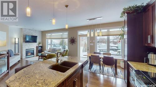 4421 Sandpiper Crescent E, Regina, SK - Indoor Photo Showing Kitchen With Fireplace With Double Sink