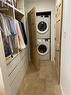 Laundry area featuring stacked washer and clothes dryer and light wood-type flooring - 67 Louisa Street, Kitchener, ON  - Indoor Photo Showing Laundry Room 