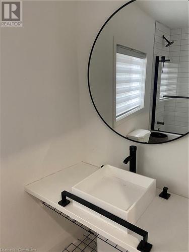 Bathroom featuring sink and a tile shower - 67 Louisa Street, Kitchener, ON - Indoor