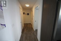 Corridor featuring dark wood-type flooring - 