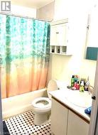 Full bathroom featuring vanity, shower / tub combo with curtain, and toilet - 