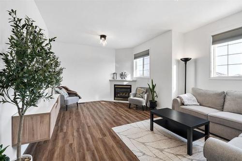 288 De La Seigneurie Boulevard, Winnipeg, MB - Indoor Photo Showing Living Room With Fireplace