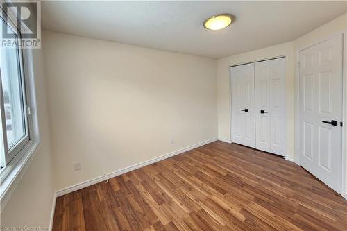 Unfurnished bedroom with dark hardwood / wood-style flooring and a closet - 39 Bridlewreath Street, Kitchener, ON - Indoor Photo Showing Other Room