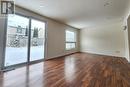 Empty room featuring dark wood-type flooring and a textured ceiling - 39 Bridlewreath Street, Kitchener, ON  - Indoor Photo Showing Other Room 