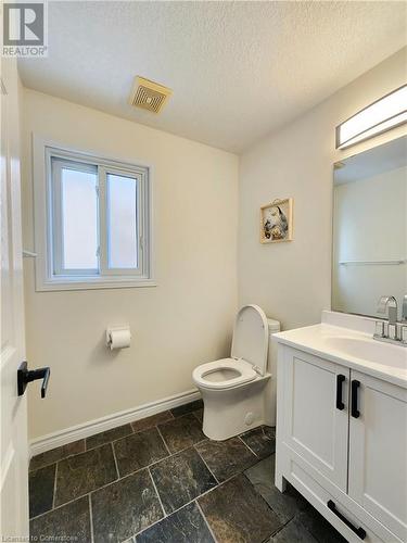 Bathroom with vanity, a textured ceiling, and toilet - 39 Bridlewreath Street, Kitchener, ON - Indoor Photo Showing Bathroom