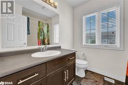 Bathroom featuring a shower with curtain, vanity, tile patterned floors, and toilet - 