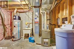 Utility room featuring gas water heater - 