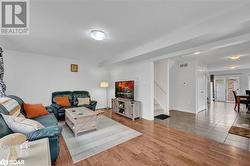 Living room featuring wood-type flooring and a textured ceiling - 