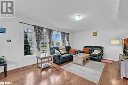 Living room with hardwood / wood-style flooring and a textured ceiling - 