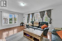 Living room with hardwood / wood-style floors and a textured ceiling - 