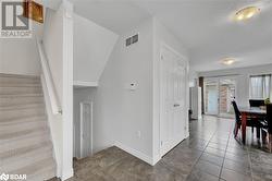 Stairs with tile patterned flooring and a textured ceiling - 