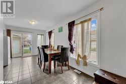 Tiled dining area with a textured ceiling - 