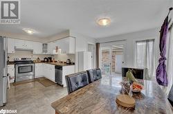 Kitchen featuring white cabinetry, sink, a textured ceiling, and appliances with stainless steel finishes - 