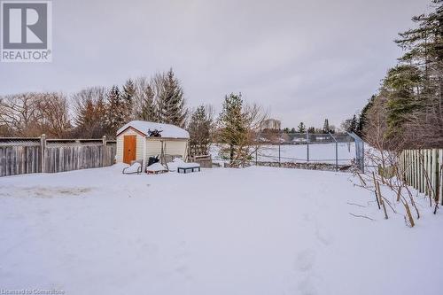 Yard layered in snow with a storage unit - 66 Karen Walk, Waterloo, ON - Outdoor