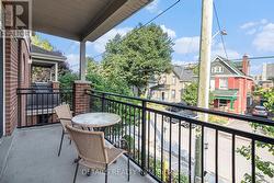 Covered patio overlooking tree lined street - 