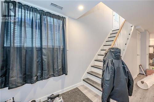 Stairway with hardwood / wood-style floors - 82 Conway Drive, Kitchener, ON - Indoor Photo Showing Other Room