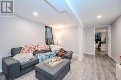 Living room featuring decorative columns and light wood-type flooring - 