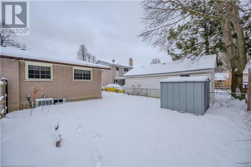 Snow covered property with a shed and cooling unit - 82 Conway Drive, Kitchener, ON - Outdoor With Exterior