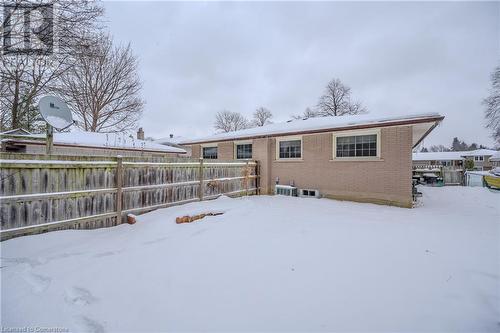 Snow covered rear of property with cooling unit - 82 Conway Drive, Kitchener, ON - Outdoor With Exterior