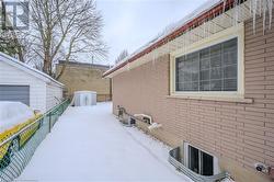 View of snowy exterior with a storage unit - 