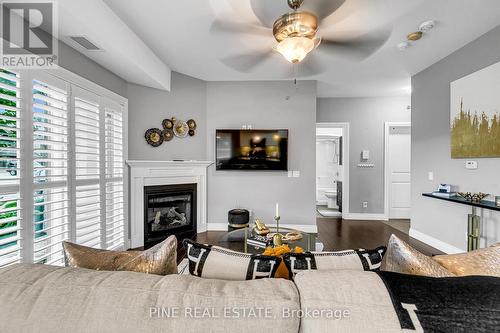 110 - 8475 Wyandotte Street E, Windsor, ON - Indoor Photo Showing Living Room With Fireplace