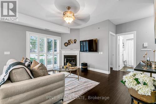 110 - 8475 Wyandotte Street E, Windsor, ON - Indoor Photo Showing Living Room With Fireplace