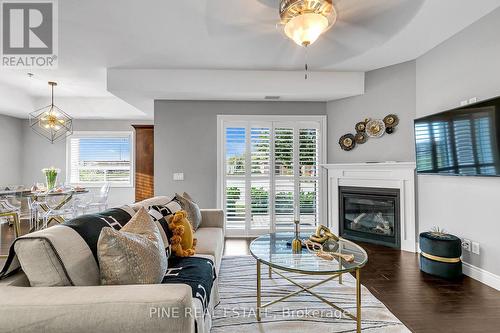 110 - 8475 Wyandotte Street E, Windsor, ON - Indoor Photo Showing Living Room With Fireplace