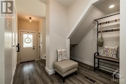 Front hall with powder room, inside access to garage, and closet. - 