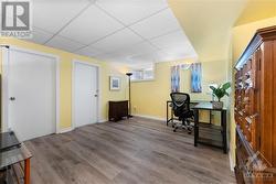 Finished lower level rec room, currently used as an office. - 