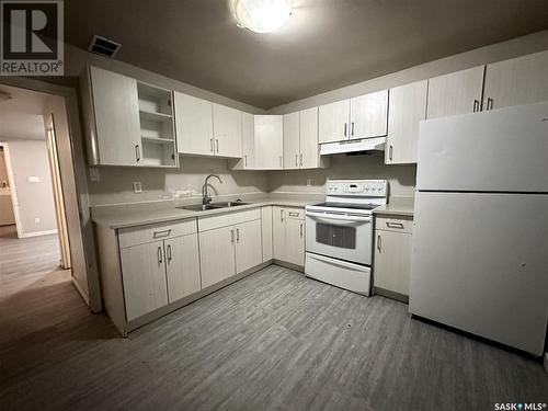 704 P Avenue N, Saskatoon, SK - Indoor Photo Showing Kitchen With Double Sink