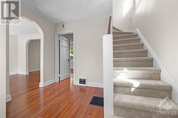 Spacious and bright foyer and new carpeting on stairs - 