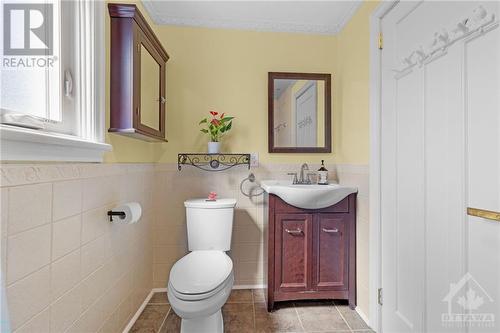 Updated and bright main bath with storage space and intricate tile detailing. - 11 Gilchrist Avenue, Ottawa, ON - Indoor Photo Showing Bathroom