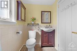 Updated and bright main bath with storage space and intricate tile detailing. - 