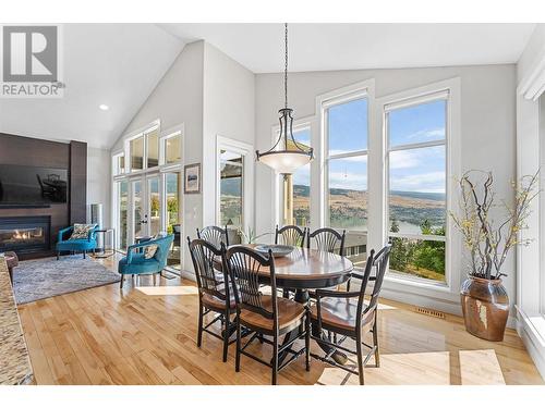 2707 Cliffshore Drive, Lake Country, BC - Indoor Photo Showing Dining Room With Fireplace