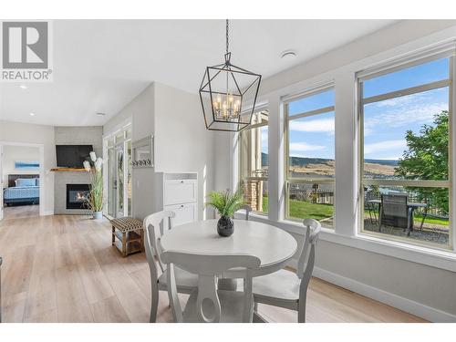 2707 Cliffshore Drive, Lake Country, BC - Indoor Photo Showing Dining Room With Fireplace