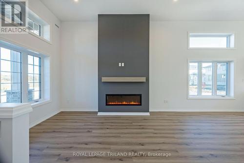 54 Snowy Owl Trail, Central Elgin, ON - Indoor Photo Showing Other Room With Fireplace