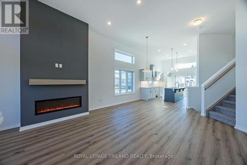 54 Snowy Owl Trail, Central Elgin, ON - Indoor Photo Showing Other Room With Fireplace