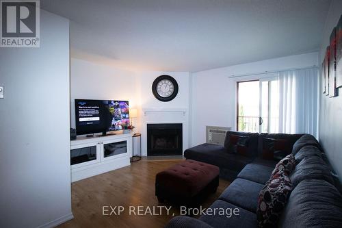 324 - 1500 Pilgrims Way, Oakville, ON - Indoor Photo Showing Living Room With Fireplace