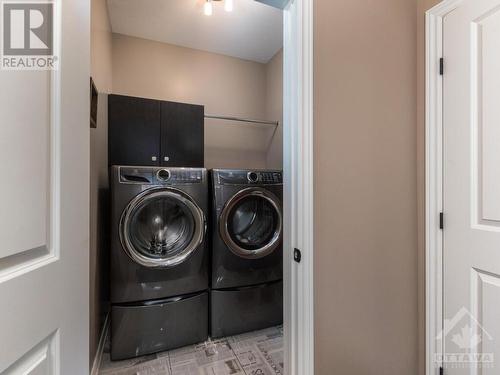 Main floor laundry has the most unique floor tile.  And a rod for drying your clothes. - 322 Tucana Way, Ottawa, ON - Indoor Photo Showing Laundry Room