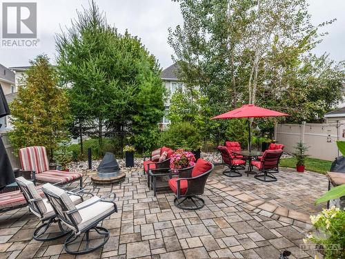 Gorgeous backyard for every season!! Automatic lights and a natural gas fireplace.  There is a natural gas BBQ too! And the mature trees give you privacy from your backyard neighbours. - 322 Tucana Way, Ottawa, ON - Outdoor With Deck Patio Veranda