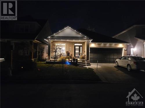 The custom front door shows off at night.  No blinds needed! - 322 Tucana Way, Ottawa, ON - 