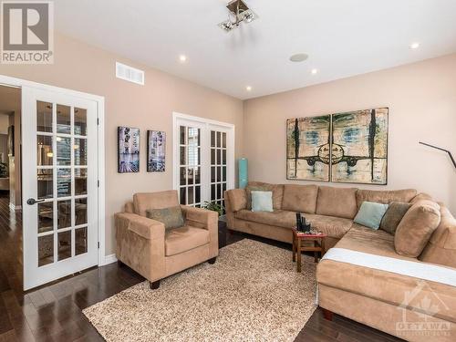 These original owners loved the space in the large sunroom so they opted for the extended version which also makes the home theatre in the basement larger. - 322 Tucana Way, Ottawa, ON - Indoor Photo Showing Living Room