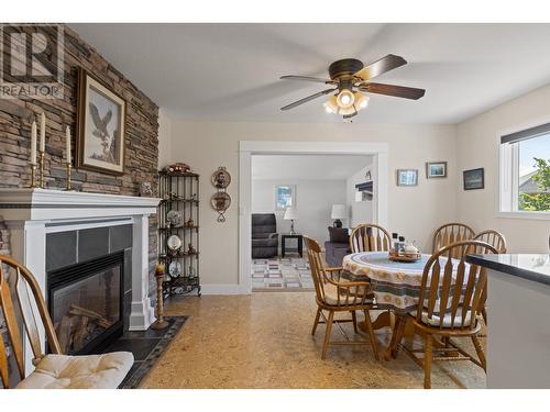 6109 Thwaite Crescent, Peachland, BC - Indoor Photo Showing Dining Room With Fireplace