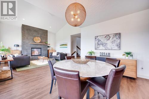 1459 Rocky Point Drive, Kelowna, BC - Indoor Photo Showing Dining Room With Fireplace